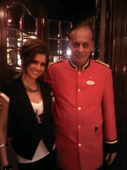 Cheryl Cole poses with hotel staffer in a familiar outfit