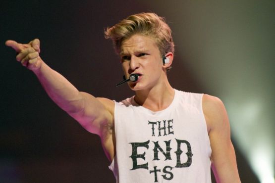 Cody Simpson points to the crowd, displaying some armpit hair, during his performance at Rogers Arena in Vancouver for We Day on October 18th