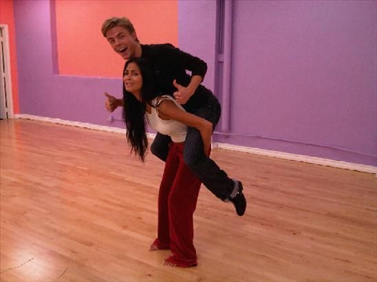 Nicole Scherzinger gives Derek Hough a piggyback ride