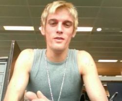 Aaron Carter wearing a grey tank top