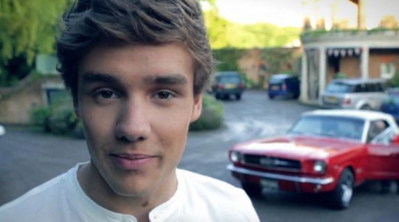 Liam Payne with a convertible Mustang in the background talking about the One Direction photo shoot wrapping up