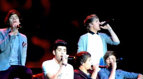 Niall Horan, Zayn Malik, Liam Payne, Harry Styles and Louis Tomlinson of One Direction, seen here performing live in Toronto, discuss the Radio 1 Teen Awards performance and an incident where Harry was oddly squirted with water while driving by two men