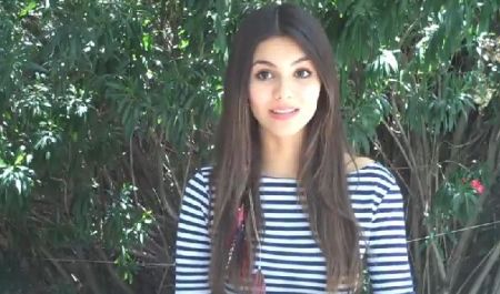 Victoria Justice, seen here in stripes, is among the pop artists reacting to the news of a tragic killing spree at Sandy Hook Elementary School